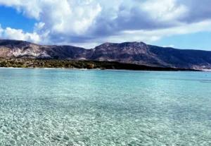 Crete Beaches, clear blue water with mountains in the background