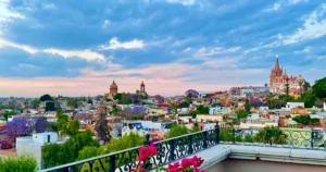 San Miguel de Allende Mexico images of skyline from the Rosewood hotel with a blue pink sky and the Parroquia de San Miguel Arcángel in the distance
