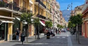 Downtown Sorrento street with yellow colored buildings and trees lining the street