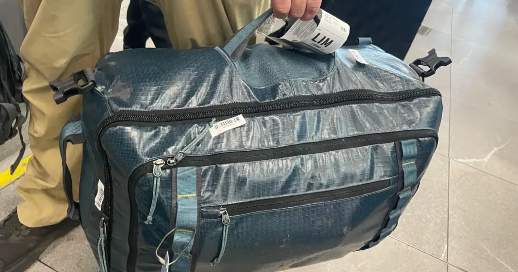 Me holding my bag at the airport