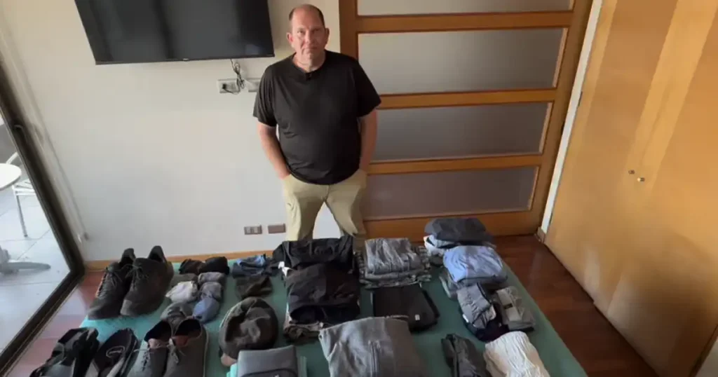 Dan in front of his packing items on bed