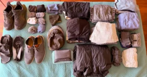 Dans clothes on bed showing what he packs