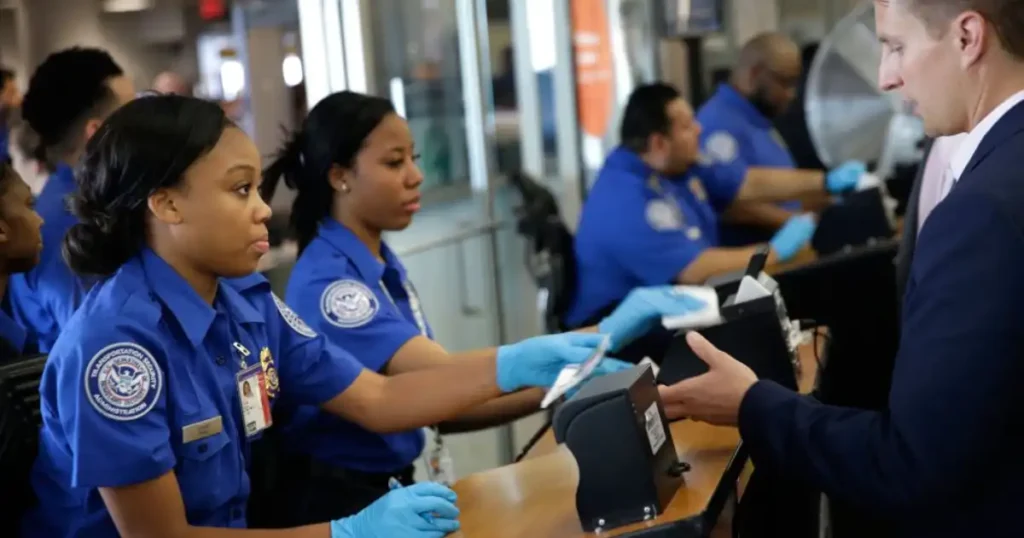 A TSA agent processing a passenger at the airport